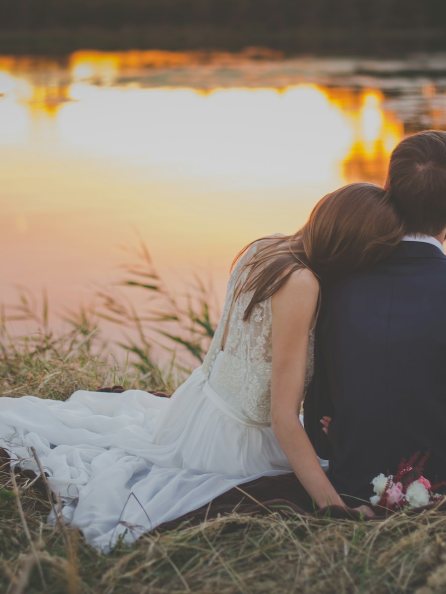 Couple watching the sun set over the water