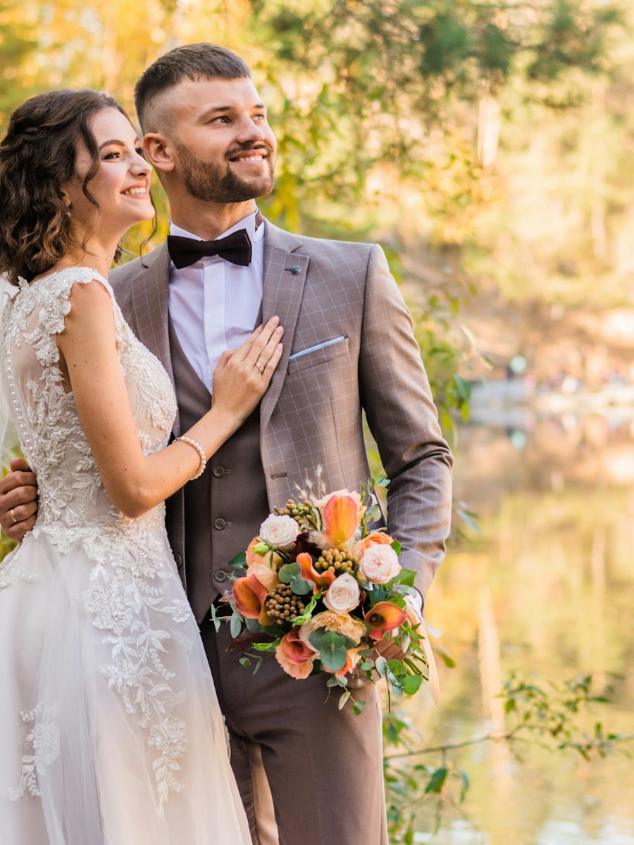 Bride and groom in a quiet portrait by the water
