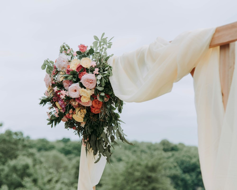 A bridal bouquet hanging from a ceremony arch